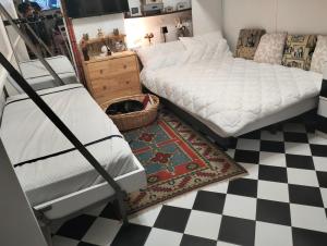 a bedroom with two bunk beds and a checkered floor at Il Quadrifoglio in Arenzano