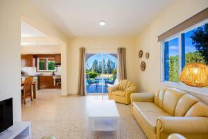 a living room with a couch and a table at Villa Christina in Argaka