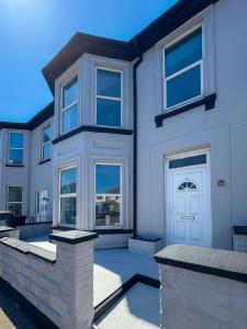 a white house with a white door and windows at Nelson Road North in Great Yarmouth