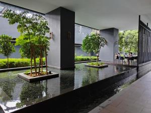 a house with trees in the middle of a river at KLCC by Star Residences in Kuala Lumpur