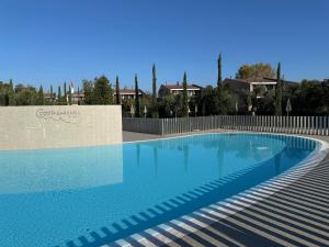 a large swimming pool with blue water at Villaggio Barbara in Moniga