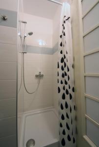 a bathroom with a shower with a shower curtain at Studio Dolac Centar in Zagreb