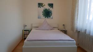 a bedroom with a bed with a purple blanket at Haus Weyers in Kressbronn am Bodensee