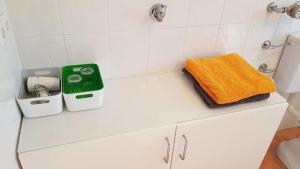 a bathroom with a sink and a towel on a counter at Haus Weyers in Kressbronn am Bodensee +35 photos