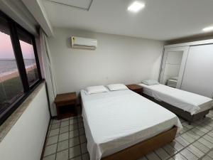 En eller flere senge i et værelse på Frente para o mar - 02 quartos