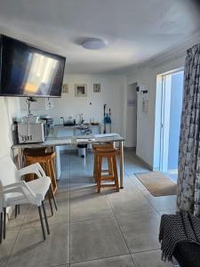 a kitchen with a table and chairs and a sink at The Somerset nest in Cape Town