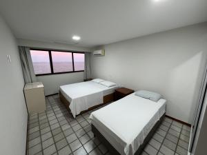 En eller flere senge i et værelse på Frente para o mar - 02 quartos