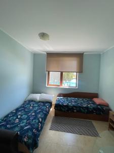 a bedroom with two beds and a window at private apartments in Apolon in Ravda +74 photos
