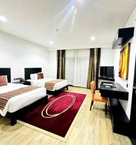 A bed or beds in a room at Amaryllis Hotel Blantyre