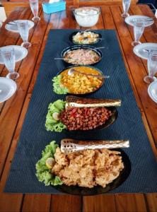 a table with many plates of food on it at Jojo Komodo Homestay in Komodo