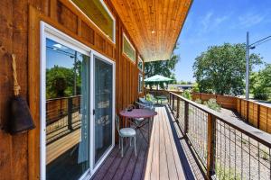 a wooden balcony with a table and chairs on it at Celias Garden in Graton