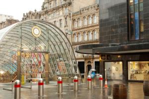 a city street with a large building with a glass at VCity Suites at The Teacher in Glasgow +71 photos