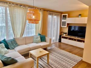 a living room with a couch and a flat screen tv at Modern Villa with Garden in Evksinograd, Varna by Flat manаger in Varna City