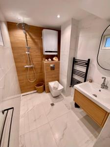 a bathroom with a toilet and a sink at Modern Villa with Garden in Evksinograd, Varna by Flat manаger in Varna City