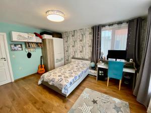 a bedroom with a bed and a desk and a computer at Modern Villa with Garden in Evksinograd, Varna by Flat manаger in Varna City