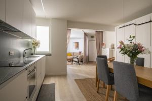 a kitchen and dining room with a table and chairs at Apartamento Vargas 2BDR in Santander