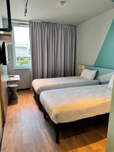 Posteľ alebo postele v izbe v ubytovaní ibis budget Nancy Laxou