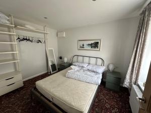 a bedroom with a bed and a book shelf at Dainville Retreat in Skegness