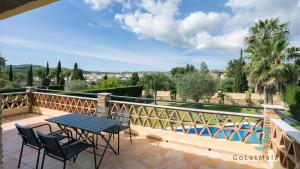 a patio with a table and chairs on a balcony at Villa Hole in One - GoLetMalaga in Mijas Costa