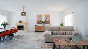 a living room with a couch and a table at Villa Hole in One - GoLetMalaga in Mijas Costa