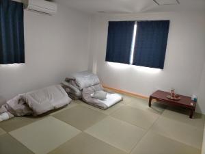 a room with a bean bag chair and a table at 民宿冬乃梅 in Saga