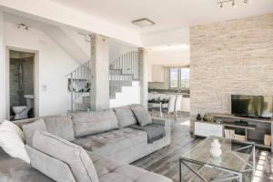 a living room with a couch and a television at Villa Katrina in Svoronata