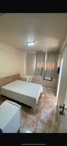 Ένα ή περισσότερα κρεβάτια σε δωμάτιο στο Hotel Gerais Business