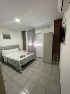 a bedroom with a bed and a television in it at MHrosa in Valencia