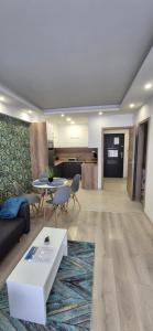 a living room with a couch and a table at Oasis Apartman in Hajdúszoboszló