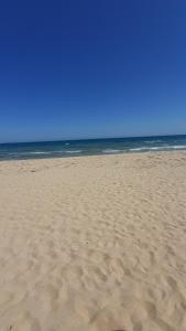 a sandy beach with the ocean in the background at Тематичен Пентхаус Несебър България in Nesebar +55 photos