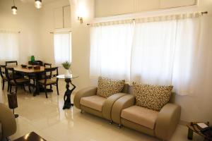 a living room with a couch and a table at 3 Keys Villa in Nashik