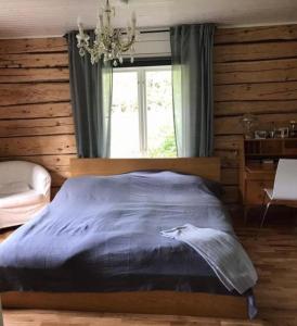 a bedroom with a bed with a cat on it at Stor Familjegård i bra läge in Finström +25 photos