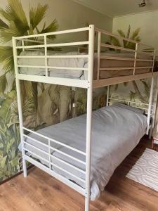 a bunk bed in a room with a white bunk bed at Rumah Bersama Kempenbos in Diessen