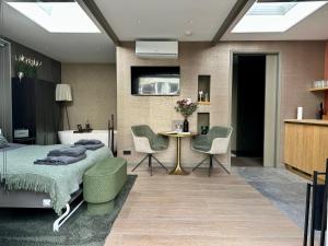 a bedroom with a bed and a table and chairs at City Oasis in The Hague