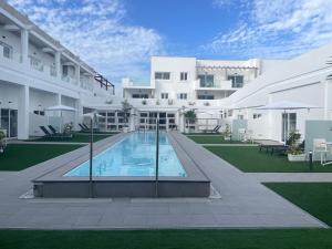an exterior view of a building with a swimming pool at Island Home Fuerteventura in Corralejo