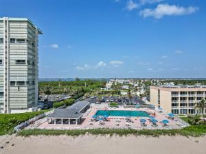 an aerial view of a pool with chairs and umbrellas at Bluewater Haven in Jensen Beach