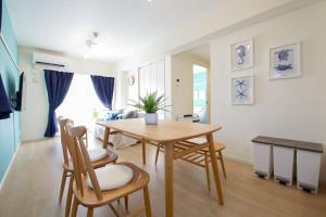 a kitchen and dining room with a table and chairs at 沖縄aw-space in Naha +33 photos