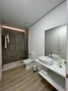 a bathroom with a toilet and a sink and a shower at Island Home Fuerteventura in Corralejo