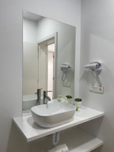 a white bathroom with a sink and a mirror at Island Home Fuerteventura in Corralejo