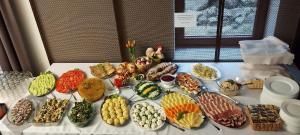 a table topped with lots of different types of food at Hotel Dobry Klimat in Szklarska Poręba