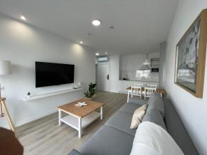a living room with a couch and a table at Island Home Fuerteventura in Corralejo
