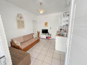 a living room with a couch and a kitchen at Veranda Apartment Paralia Ofriniou in Ofrínion +25 photos