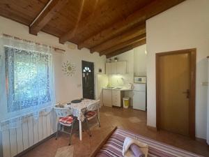 a living room with a table and a kitchen at Apartments Silvi in Medulin