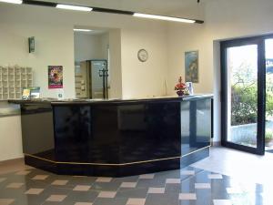 a lobby with a large black counter in a room at Residence Tre Ponti in Verbania