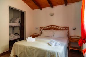 Postel nebo postele na pokoji v ubytování B&B Agriturismo 'A Cunziria