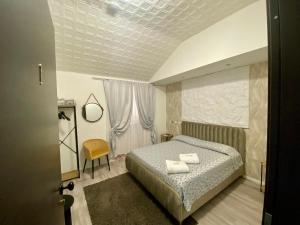 A bed or beds in a room at Guest House Minas