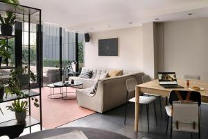 a living room with a couch and a table with a laptop at Park House Hotel Museum Quarter, Sonder by Marriott Bonvoy in Amsterdam