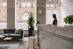 a woman sitting at a counter in a room at Sonder by Marriott Bonvoy Royal Garden Apartments New Town in Edinburgh