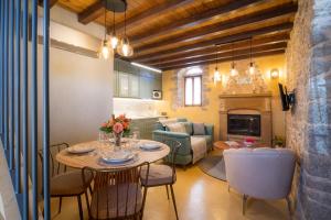 a kitchen and living room with a table and chairs at Mills Residence in Ágios Geórgios Sykoúsis