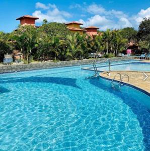 a large swimming pool in front of a resort at Casa Quinta do Atlântico - Aconchego da Paz 150m da praia in Búzios